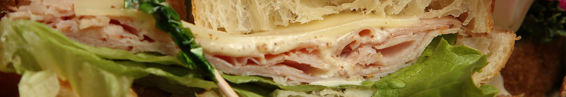 Eating Sandwich Cafe at Breadwinner Cafe and Bakery restaurant in Sandy Springs, GA.